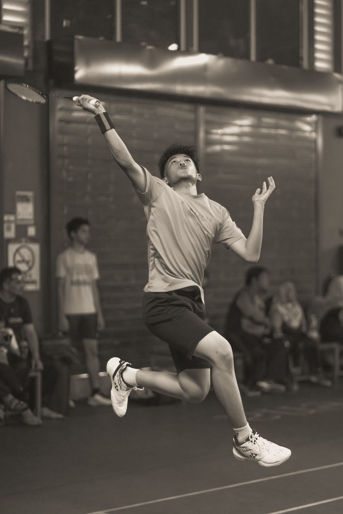 A player leaps for a smash