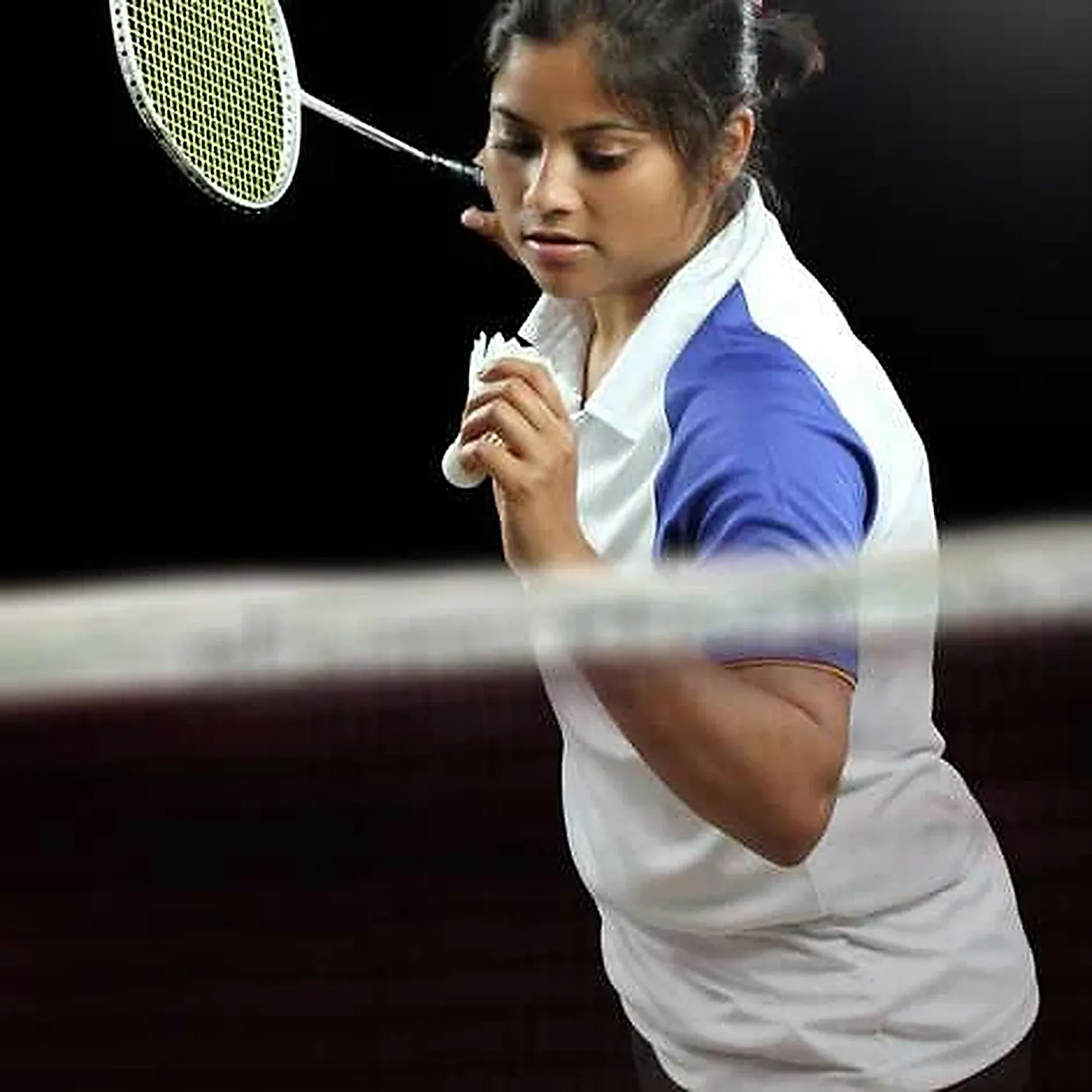 A player concentrates on the shuttle at the net