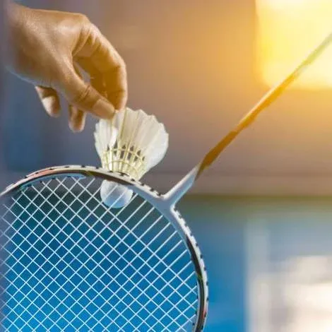 Close-up of a racket and shuttle at the serve