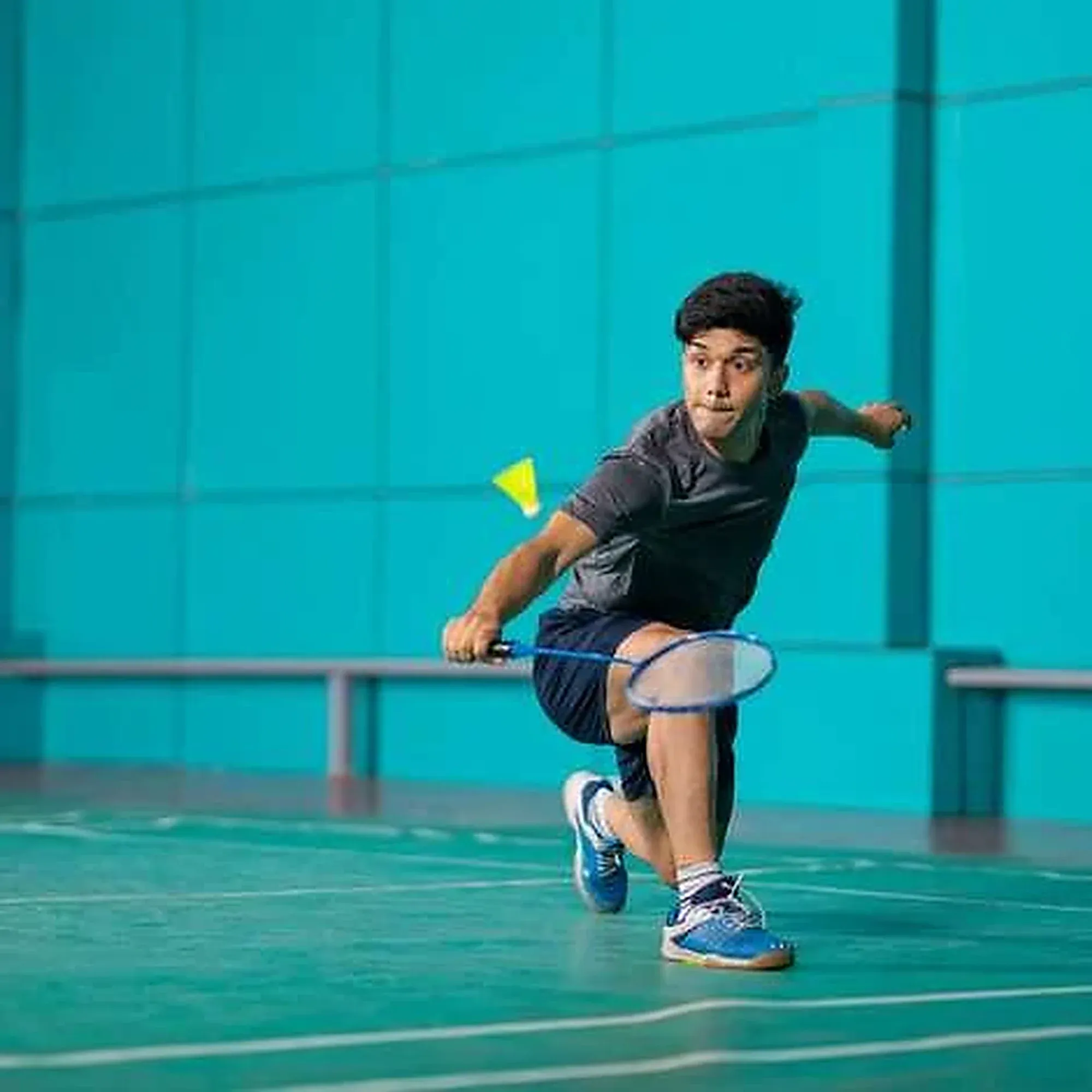 A player lunges low to return a shuttle